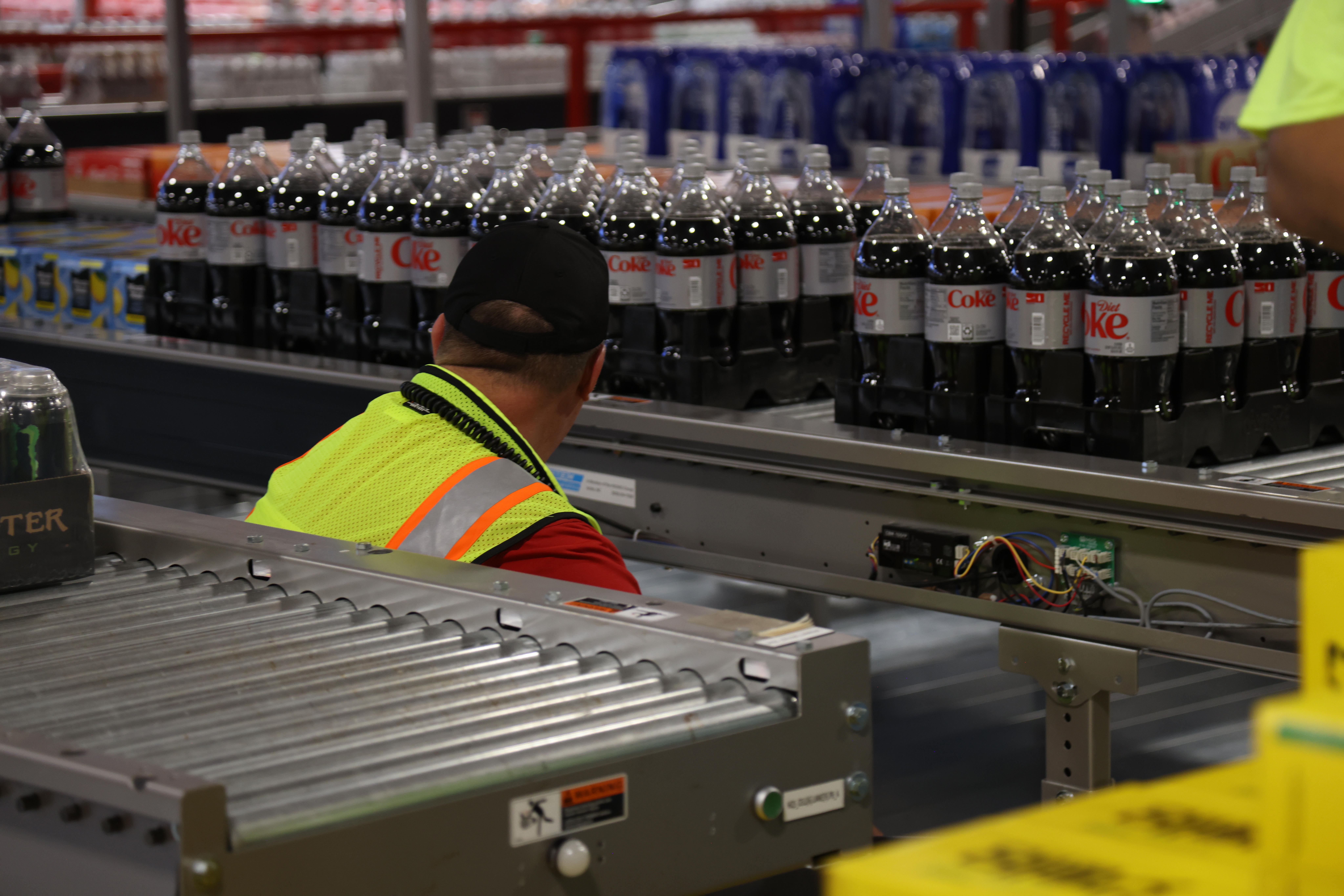 A line operator monitors product at a Coca-Cola Consolidated facility. MUST's real-time data has helped operators and maintenance teams identify equipment issues faster and with less wasted film.