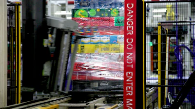 A mixed pallet of Coca-Cola Consolidated products receives stretch film. Different products require different wrap recipes, each maintained by Must to its own benchmark.