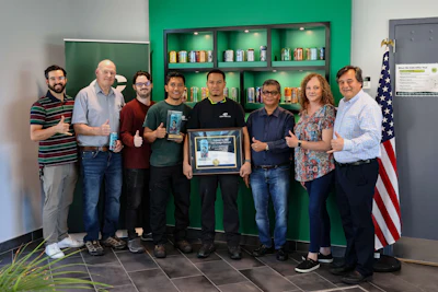 Members of the Can-One USA team celebrate the company's Colored by INX Can Design Contest win, from left: Nick Hanna, former Head of Creative & Branding; Jeff Fontaine, Plant Superintendent/CTS Manager; Aric Leighton, Prepress & Design Lead; Eko Aprianto, Engineering Assistant Manager; Darith Em, General Production Maintainer; Chaidir Umar, Plant Manager; Anna Pichico, Graphic Designer; and CEO Giovanni Di Mambro.