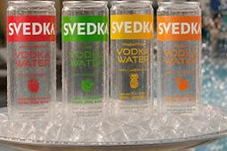 The transparent can is designed to showcase the product's composition, which includes vodka, purified water and fruit flavoring, while reinforcing visual clarity as a key packaging feature.