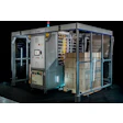 Industrial automated packaging machine with blue frame, control panels, and cardboard boxes on conveyor system