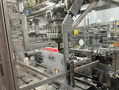 One of two robotic pickers responsible for picking bottles from a four-lane infeed conveyor and placing them into paperboard carriers that are already inside their corrugated cases