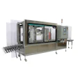 Industrial automated packaging machine with control panels and mechanical components on wheeled base
