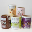 Collection of cylindrical product containers with nutritional labels displayed on white surface