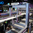 Industrial manufacturing facility with automated assembly machinery, conveyor systems, and production equipment under bright overhead lighting