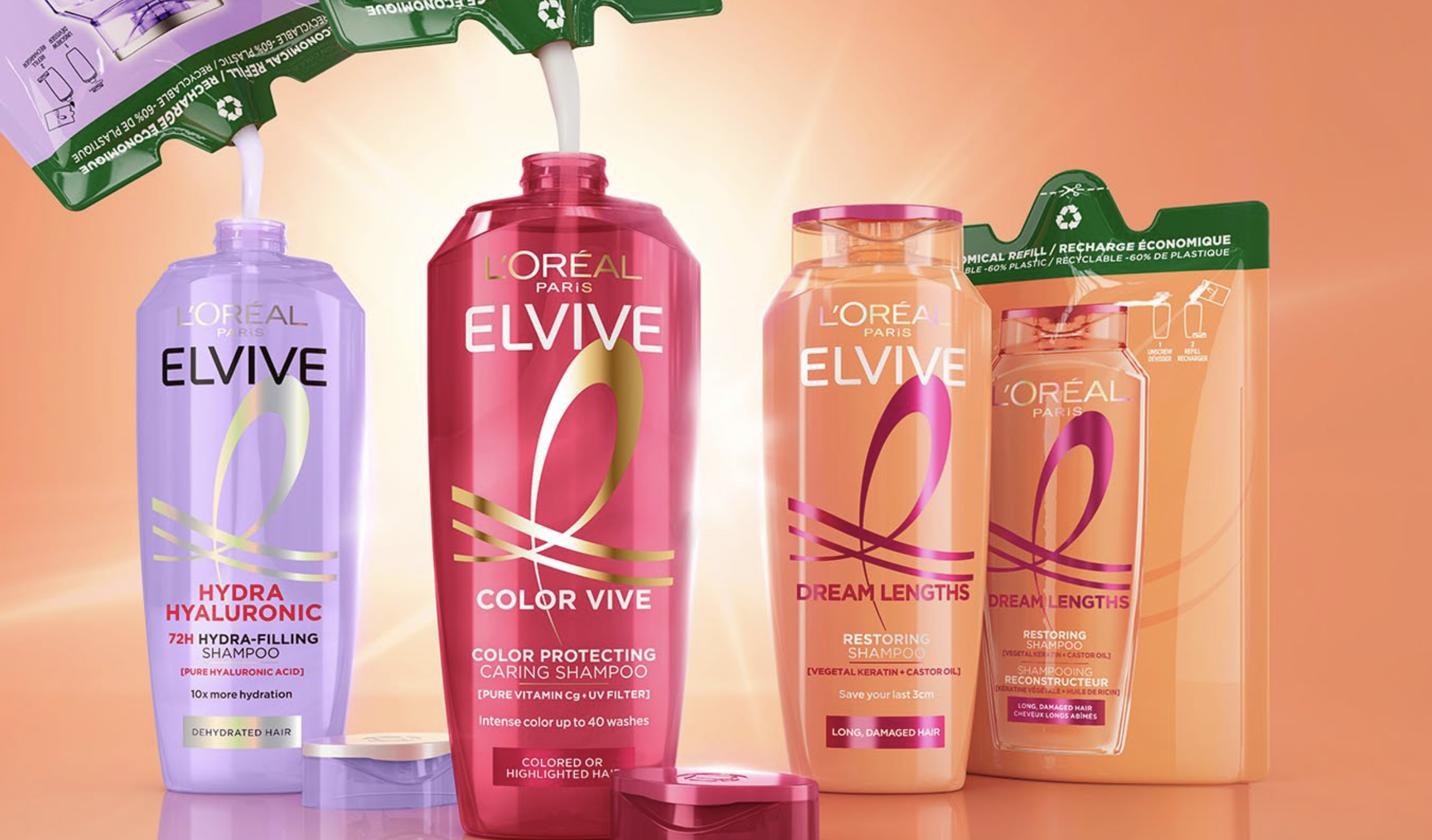 L'Oréal Elvive haircare product collection including purple hydra shampoo, burgundy color vive shampoo, and coral dream lengths conditioner bottles on gradient background
