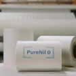 PureNil 0 branded product rolls in manufacturing facility with industrial equipment background