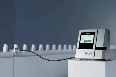 2D JET medical analyzer device with touchscreen display and sample bottles on gray background