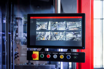 Security surveillance monitoring system displaying multiple aerial camera feeds on a screen with colored control buttons