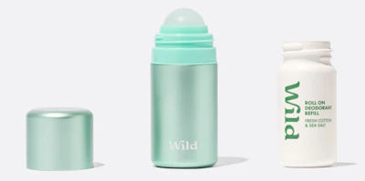 Three Wild deodorant products: mint green roll-on, matching cap, and white refill bottle with green text