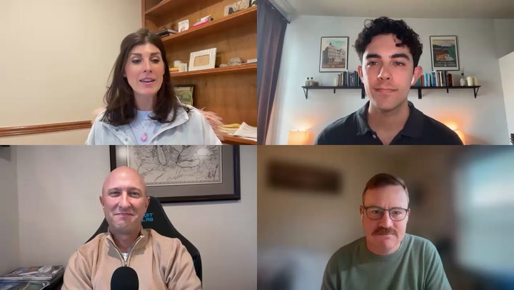 Four people participating in a video conference call displayed in a grid layout on screen.