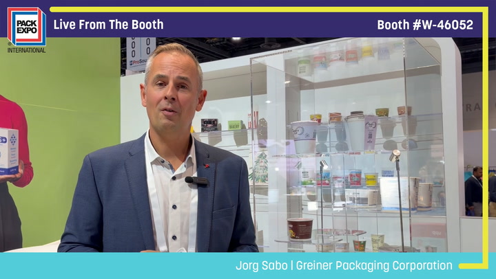 Jorg Sabo from Greiner Packaging Corporation speaking live at Pack Expo booth W-46052 with product display cases behind him