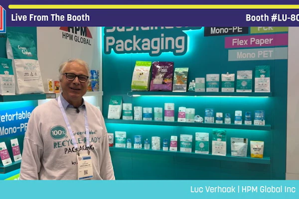 Man in glasses at sustainable packaging booth displaying eco-friendly mono-PE and flex paper products at Pack Expo trade show booth LU-8027