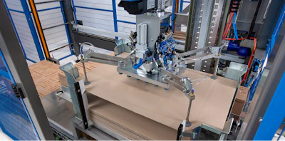 Industrial 3D printer with blue safety enclosure and mechanical components on work platform