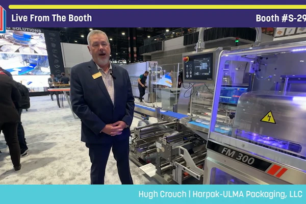 Professional demonstrating FM 300 packaging machinery at Pack Expo booth S-2939