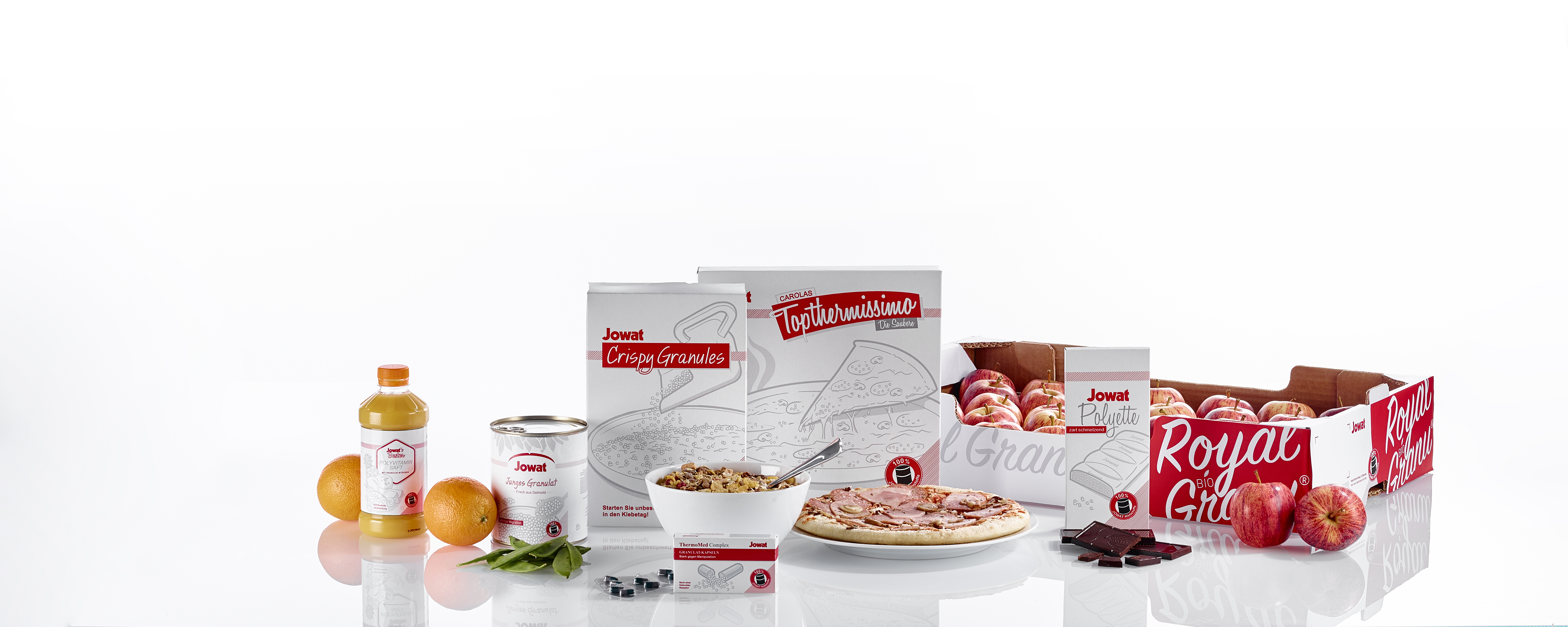Assorted bakery and food products including packaged goods, fresh ingredients, and branded items arranged on white background