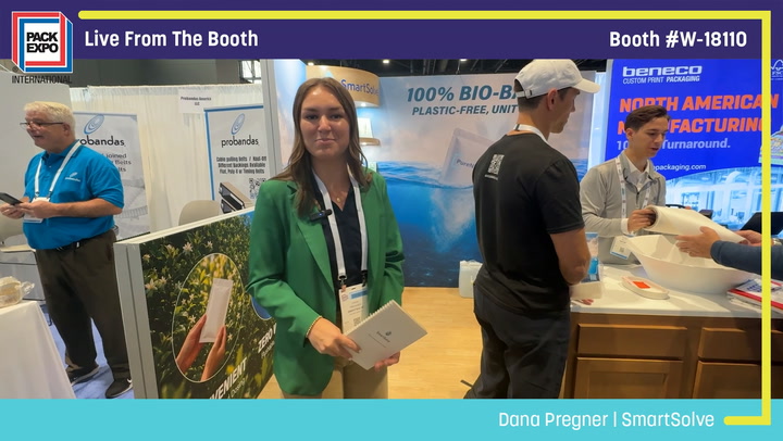 Woman in green blazer at Pack Expo booth W-18110 with team members demonstrating bio-based packaging products