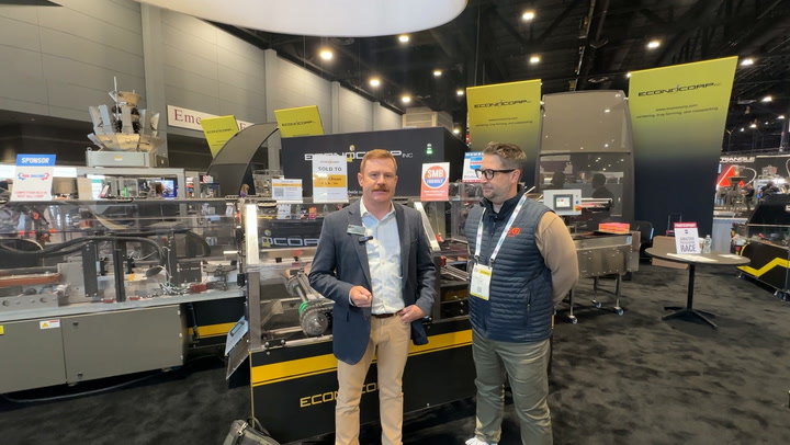 Two professionals at industrial equipment trade show booth with yellow and black ECCO machinery