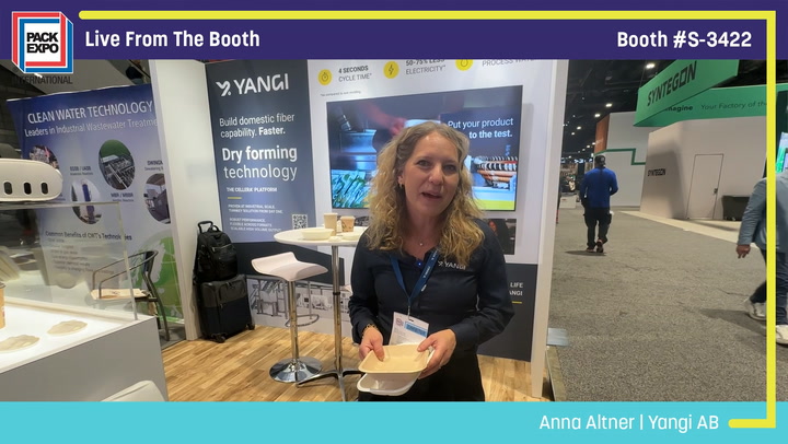 Woman presenting at Yangi AB booth during Pack Expo trade show, demonstrating dry forming technology