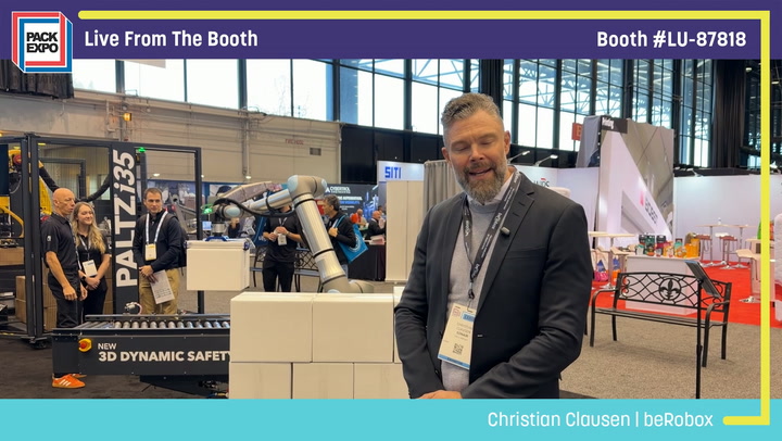 Christian Clausen from beRobox poses at Pack Expo booth LU-87818 featuring Palletizer robotic equipment