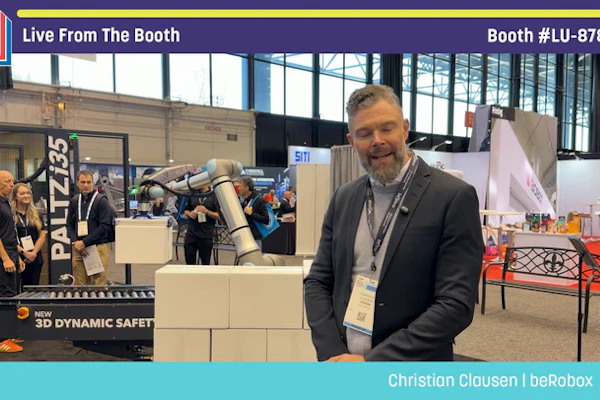 Christian Clausen from beRobox poses at Pack Expo booth LU-87818 featuring Palletizer robotic equipment
