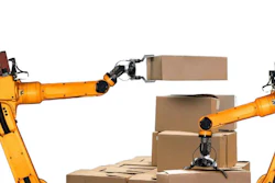 Two yellow industrial robotic arms handling cardboard boxes in an automated warehouse setting