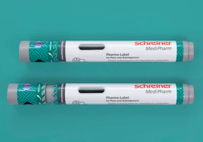 Two Schreiner MediPharm Pharma-Label tubes for pens and autoinjectors with green patterned sleeves on turquoise background