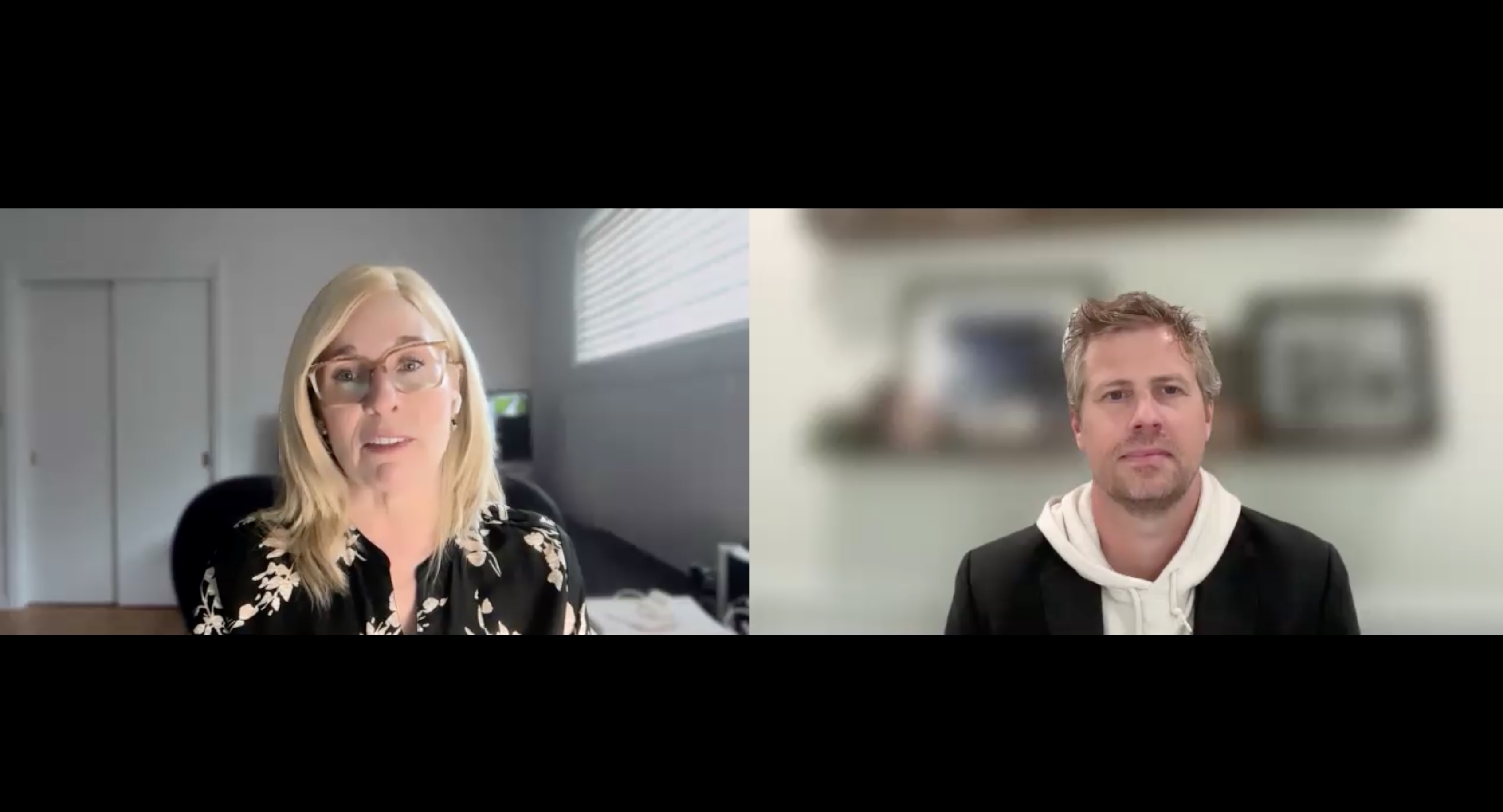 Two people in a virtual video conference call, woman on left wearing glasses and patterned jacket, man on right in black hoodie