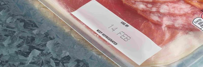 White product label with text on textured red and blue surface packaging