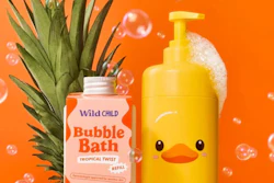 Wild Child tropical bubble bath and yellow duck-shaped soap dispenser with pineapple on orange background