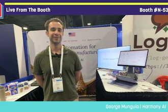 Man in green shirt at Pack Expo booth N-5384 presenting Harmony AI technology with laptop displays